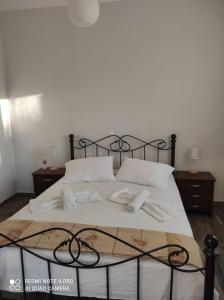 a large bed with white sheets and white pillows at Diktynna villa in Palekastron