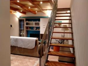 a staircase in a room with a bed and a table at Casa Bella in Siracusa