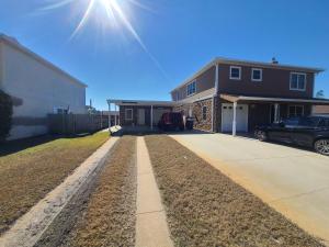 a house with a car parked in front of a driveway at Hidden Gem Guest House in Panama City Beach