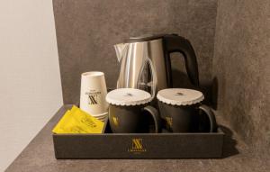 a box with a coffee maker and two cups at Urban-Est Hotel in Goyang