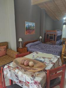 a room with two beds and a table with cookies on it at Departamento Uspallata in Uspallata