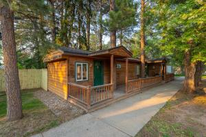 a wooden cabin in the middle of a forest at Spearfish Cottages in Spearfish