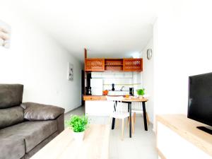 A television and/or entertainment centre at Cozy Beach Holiday Home in Playa del Ingles