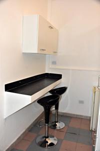 a kitchen with a black counter and a black stool at Habitación con oficina a la calle in La Rioja