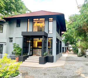 a house with a black and white building at The Henry Resort Taramindu Laiya in Batangas City