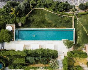 an overhead view of a swimming pool in a garden at Shunyata Villas Bali in Seraya