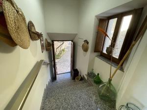 a hallway with a stairway with a window and vases at Belvilla by OYO Terrazze in Amandola