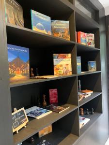 a book shelf filled with lots of books at The Henry Resort Taramindu Laiya in Batangas City