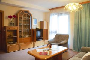 a living room with a tv and a couch and a table at Apartment in Oberdrauburg with parking space in Oberdrauburg