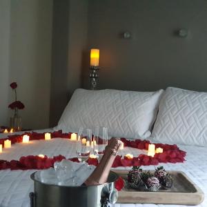 a person laying on a bed with a lit candle at Casa AMMAH in Ciudad Valles