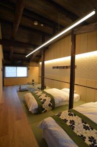 a bedroom with three beds in a room at 染 SEN 五条上長 Gojo Kamicho in Kyoto