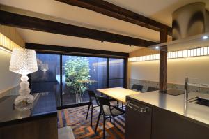 a kitchen and dining room with a table and a window at 京一軒町家 染 SEN 五条上長 Gojo Kamicho in Kyoto