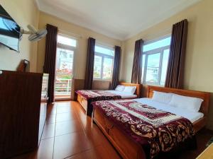 Postel nebo postele na pokoji v ubytování Đông Đức Hostel Đà Lạt