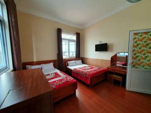 Postel nebo postele na pokoji v ubytování Đông Đức Hostel Đà Lạt