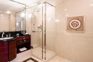 a bathroom with a shower and a sink at Maritim Hotel Taicang Garden in Taicang