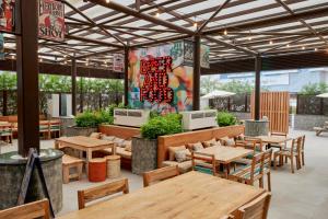 a restaurant with wooden tables and chairs and a patio at Citymax Hotel Business Bay in Dubai