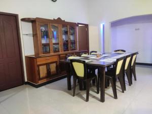 a dining room with a wooden table and chairs at Spices Garden Homestay & Plantation Tour in Madikeri