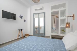 A bed or beds in a room at Aegean Jasmine - In The Center