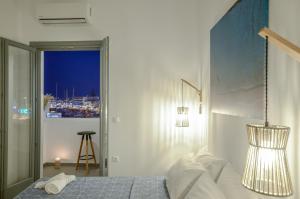 A bed or beds in a room at Aegean Jasmine - In The Center