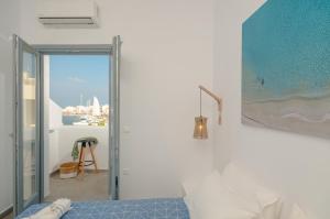 A bed or beds in a room at Aegean Jasmine - In The Center