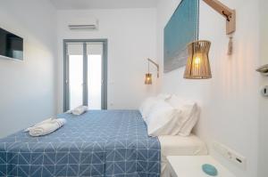 A bed or beds in a room at Aegean Jasmine - In The Center