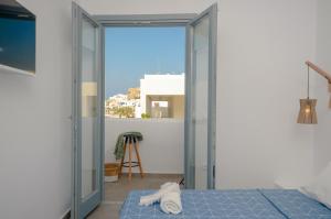 A bed or beds in a room at Aegean Jasmine - In The Center