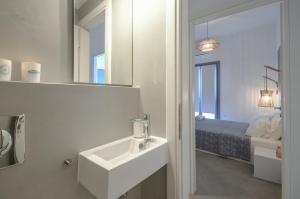 A bed or beds in a room at Aegean Jasmine - In The Center
