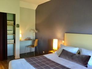 a bedroom with a bed and a table and a chair at La Grange Saint Martin in Fontaine-le-Port