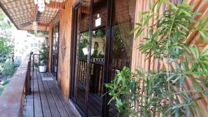 a front porch of a house with glass doors at Sea Breeze Beachfront Home and Cottages in San Juan