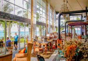 a restaurant with tables and chairs and a view of the ocean at Summer Luxury Beach Resort & Spa in Baan Tai