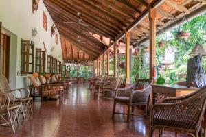 a long hallway with chairs and tables in a building at Tranquil Resort - Blusalzz Collection, Wayanad - Kerala in Ambalavayal