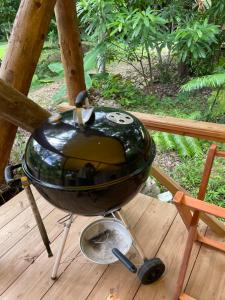 a bbq grill on a wooden deck at Ecostay Glamping Rainbow Forest in Ishigaki Island