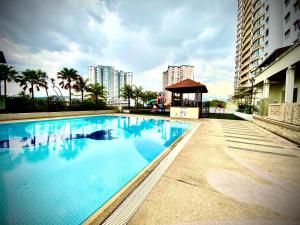 a large swimming pool with a gazebo next to a building at Monkey Mansion in Kuala Lumpur