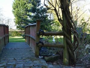 a wooden fence with a gate in a garden at Laburnum Cottage Guest House in Knutsford