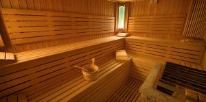 a sauna with a bucket in the middle of it at Hotel Crosal in Livigno