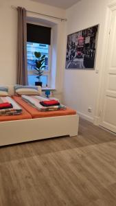 a bedroom with a bed with orange sheets and a window at Stadtnah an der Förde 75 in Flensburg +12 photos