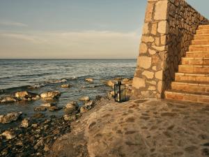 a set of stairs next to the ocean at Seaside Luxury LaTerre, Zante Zen By ThinkVilla in Psarou