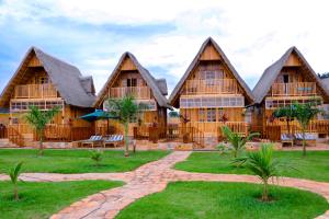 a large wooden house with a stone path in front of it at Pelican Lodge & Marina in Entebbe
