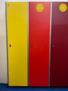zwei gelbe und rote Türen mit Aufklebern darauf in der Unterkunft Apartment 3 bedrooms with ski locker and parking at Baqueira-Beret in Arties