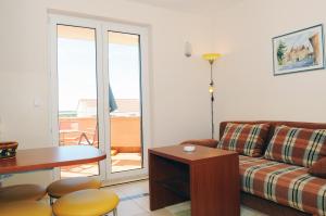 a living room with a couch and a table at Apartmani Kristiana in Jezera