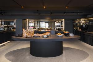 a large table with food on it in a restaurant at EmiLu Design Hotel in Stuttgart