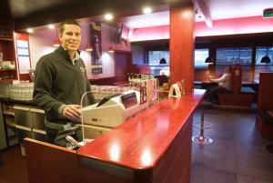 a man standing at a counter in a restaurant at Hotel Kiteenhovi in Kitee