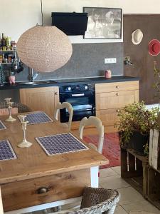 a kitchen with a wooden table and a stove at Appartement de 2 chambres avec vue sur la ville piscine partagee et jardin clos a Gaillac in Gaillac