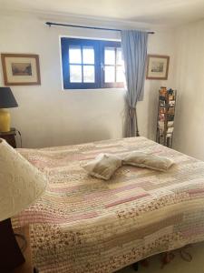 a bedroom with a bed with two pillows on it at Appartement de 2 chambres avec vue sur la ville piscine partagee et jardin clos a Gaillac in Gaillac