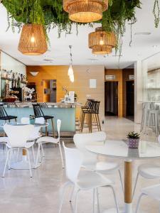 a restaurant with tables and chairs and a bar at Daniya Alicante in Alicante