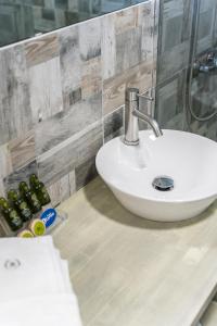 a bathroom with a white sink on a counter at Ianos Bay in Lefkada Town