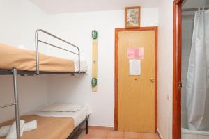 a room with two bunk beds and a door at Apartamentos Lake Placid 3000 in Pas de la Casa