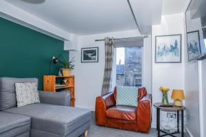 a living room with a couch and a chair at Beautiful 1-Bed Apartment near Castle in Edinburgh