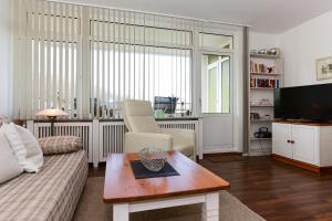 a living room with a couch and a coffee table at Haus Oland Whg 15 in Wyk auf Föhr