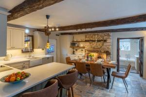 a kitchen and dining room with a table and chairs at Farthingdales in Burford
